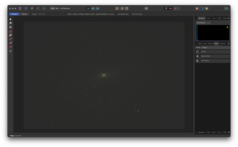 Screenshot of photo editing software showing a dark canvas with scattered light particles and a bright center point.