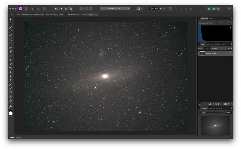 Screenshot of photo editing software displaying a deep-sky astronomical image of a bright galaxy surrounded by stars.