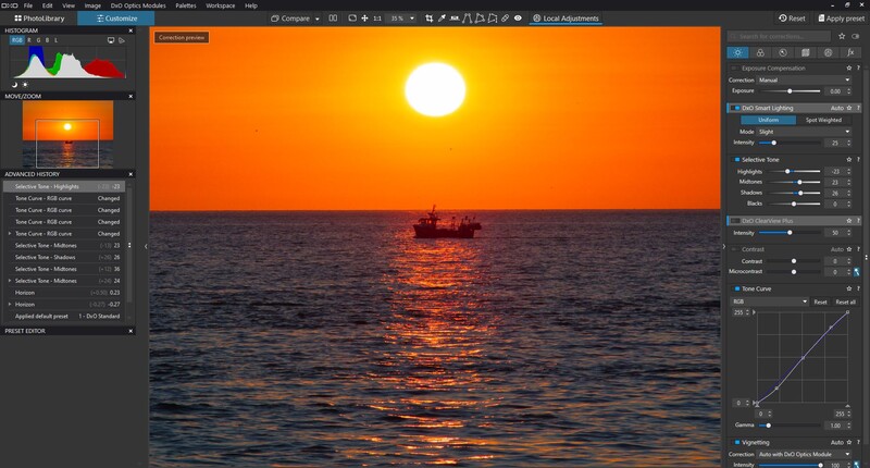 Screenshot of photo editing software showing a sunset seascape with warm orange sky and silhouetted fishing boat.