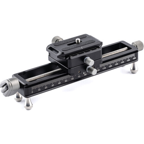 Black precision camera slider with graduated measurement scales and adjustable ball head mount.