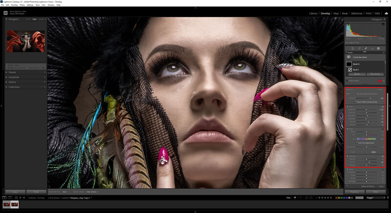 Portrait of woman with dramatic makeup and colorful feathered headpiece in editing software.