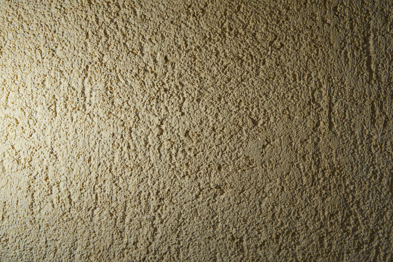 Close-up of a textured beige carpet surface with uniform pile and subtle color variations.
