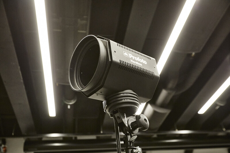 Professional studio light with ribbed cooling fins mounted on stand beneath linear LED panels.