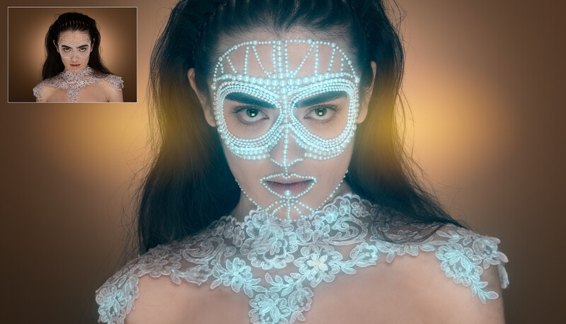 Woman with geometric light projection mapping on face and ornate lace shoulder garment.