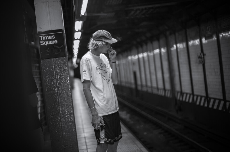 Teen smoking cigarette in subway station