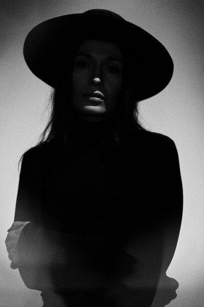 Black and White portrait of a woman wearing a hat.
