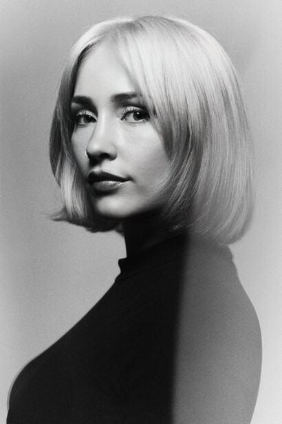 Black and white portrait of a blonde woman with short hair.