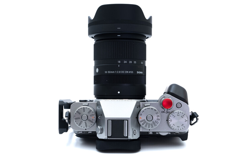 Top-down view of a mirrorless camera body with attached lens and lens hood.