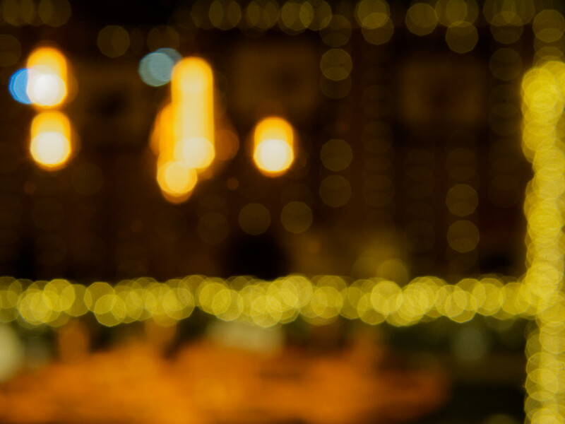 Blurred warm-toned lights and bokeh creating an out-of-focus nighttime scene.