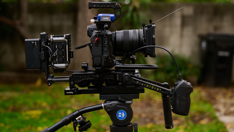 Professional cinema camera rig with follow focus system, matte box, and external monitor mounted on motorized gimbal.
