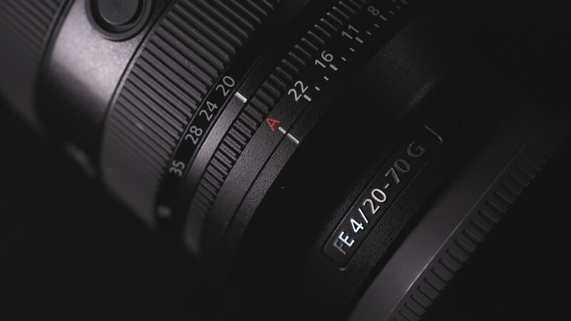 Close-up of camera lens barrel showing focal length markings and focus ring details.