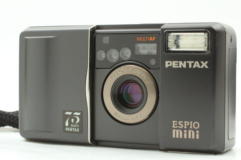 Pentax Espio mini compact film camera with flash and lens extended against white background.