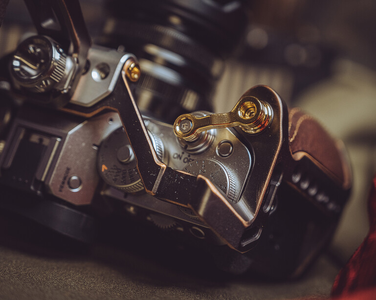 Close-up of vintage film camera mechanism with brass and metal components in selective focus.