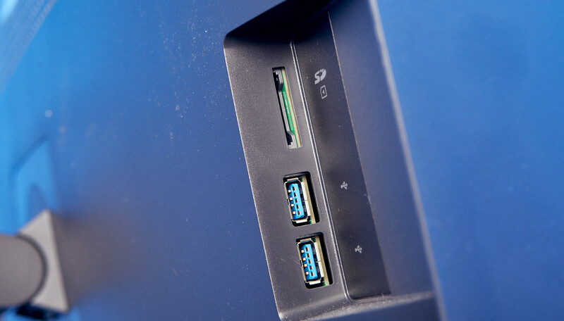 Close-up of a computer tower's front I/O ports including USB headers and card reader slot.