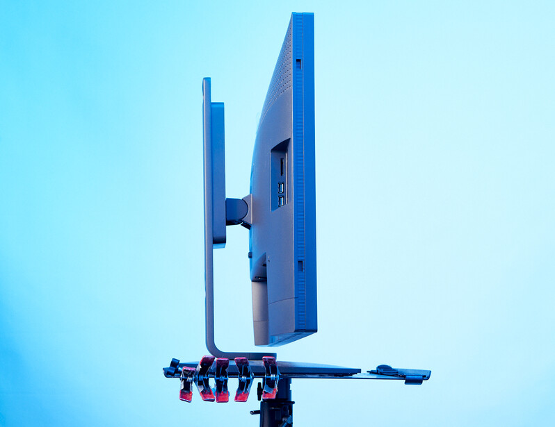 Large blue directional sign mounted on a pole against a clear sky.