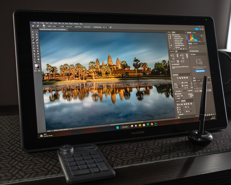 Screenshot of Adobe Photoshop displaying a landscape photograph of a golden temple reflected in still water.