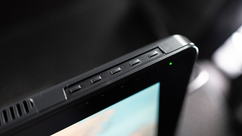 Close-up of a laptop's top edge showing control buttons and ports along the bezel.
