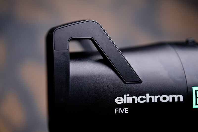 Close-up of Elinchrom Five monolight handle against blurred background.