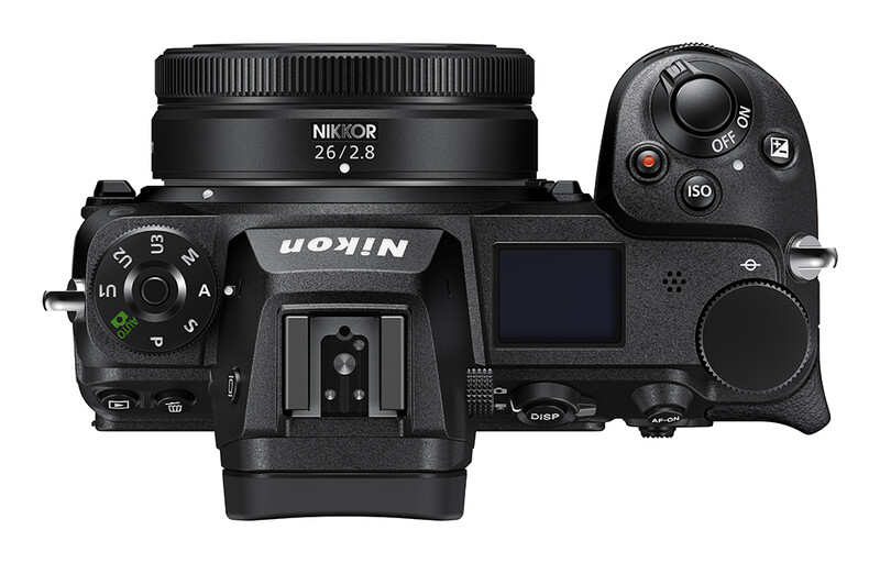 Top-down view of Nikon Z mirrorless camera with 26/2.8 lens attached and wireless remote control.