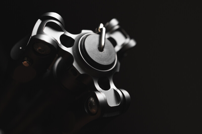 Close-up of a revolver's cylinder and barrel against a black background, front-facing angle.