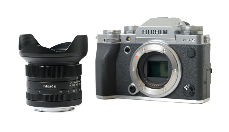 Meike ultra-wide-angle lens with hood and Fujifilm X-Pro 3 camera body displayed side by side.