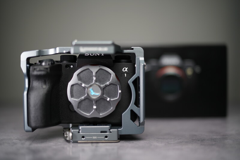Sony Alpha mirrorless camera mounted on a cage rig with a large cooling fan attachment.
