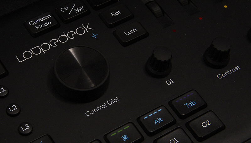 Close-up of a professional audio interface control panel with illuminated buttons and a central rotary dial labeled Control Dial.