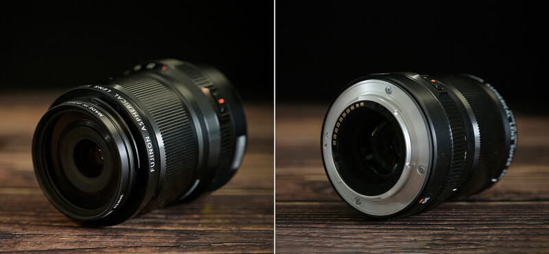 Two camera lenses displayed front and rear views on wooden surface against dark background.
