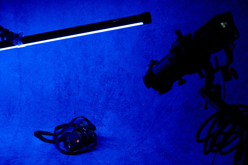 Underwater photograph of a crab on the sea floor illuminated by a diver's light and camera equipment.
