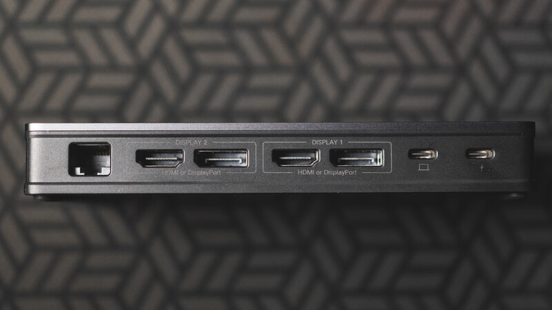 Close-up of a docking station showing multiple display ports and USB connections against a patterned background.