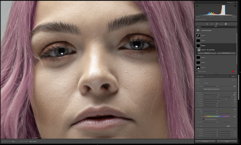Close-up portrait of a person with pink hair and neutral expression during editing in post-production software.