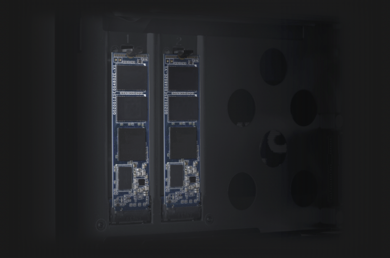 Two vertical circuit boards with illuminated components and circuitry against a dark background.