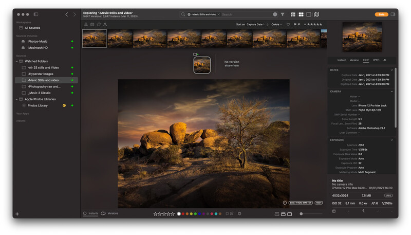 Screenshot of photo editing software displaying a desert landscape with golden rock formations and a bare tree at sunset.