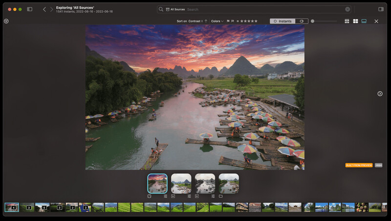Landscape photograph of a riverside village at sunset with dramatic orange and purple sky.