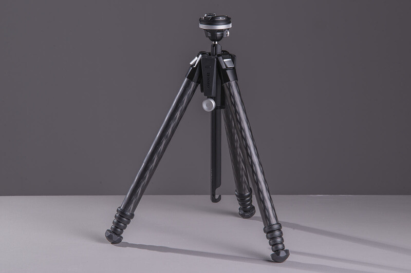 Professional camera tripod with three extended legs and ball head mount against neutral background.