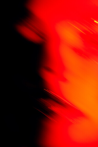Abstract composition of red and orange gradient shapes with sharp diagonal lines and high contrast black shadows.