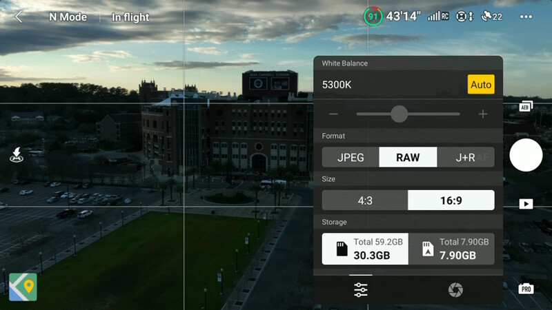 Screenshot of mobile camera app showing shooting controls and white balance settings overlay on cityscape.
