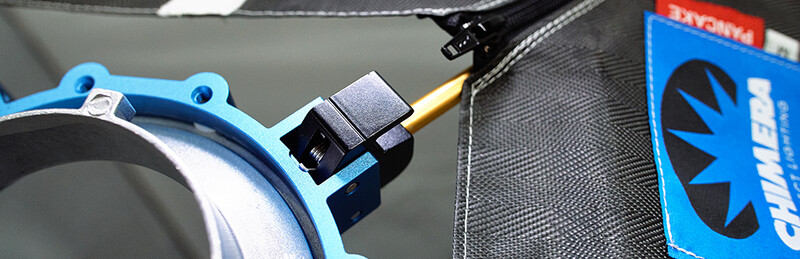 Close-up of a blue mechanical component with cable and black connector mounted on equipment.