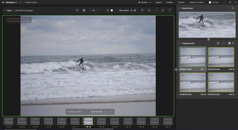 Surfer riding a wave in moderate ocean swells near the shoreline.