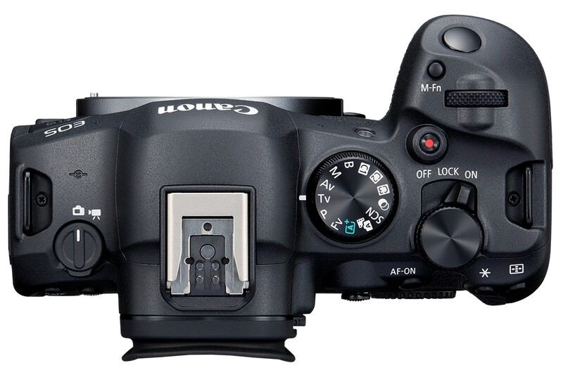 Top-down view of a Canon EOS R5 mirrorless camera body showing mode dial, controls, and hot shoe.
