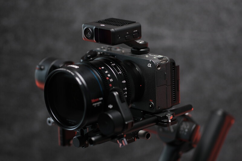 Professional cinema camera with mounted matte box, follow focus system, and external recorder on tripod rig.