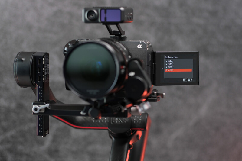 Sony mirrorless camera mounted on gimbal stabilizer with external monitor and microphone.