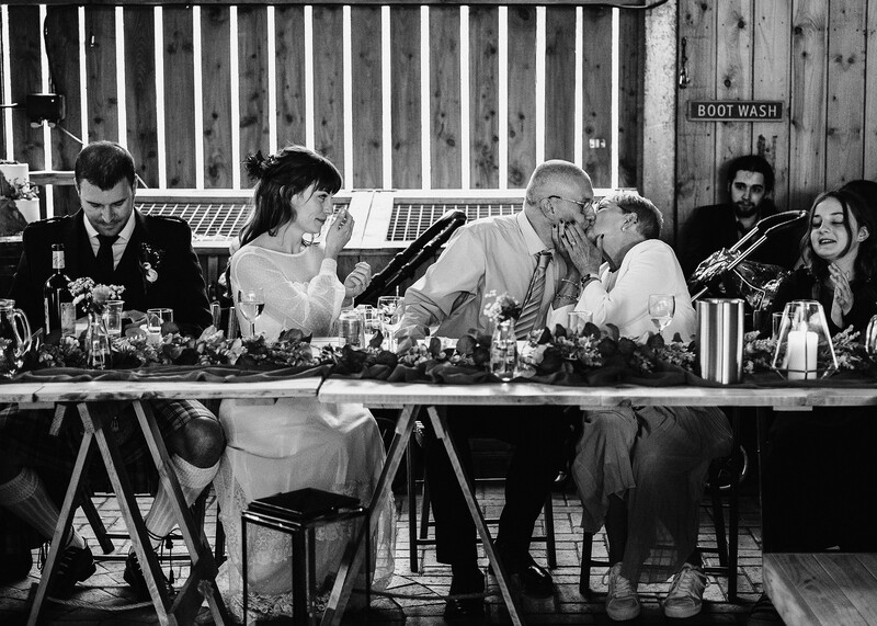 Black and white photograph of six people seated at a long table during what appears to be a panel discussion or formal event.