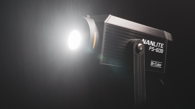 Nanlite FS-60B LED light fixture mounted on stand against dark background, emitting bright white light.