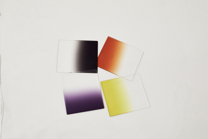 Four color gradient test cards displaying transitions from white to black, orange to yellow, purple to black, and yellow gradations.