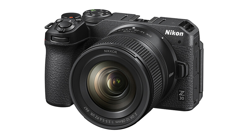 Nikon Z30 mirrorless camera with attached zoom lens, shown at a three-quarter angle against a white background.