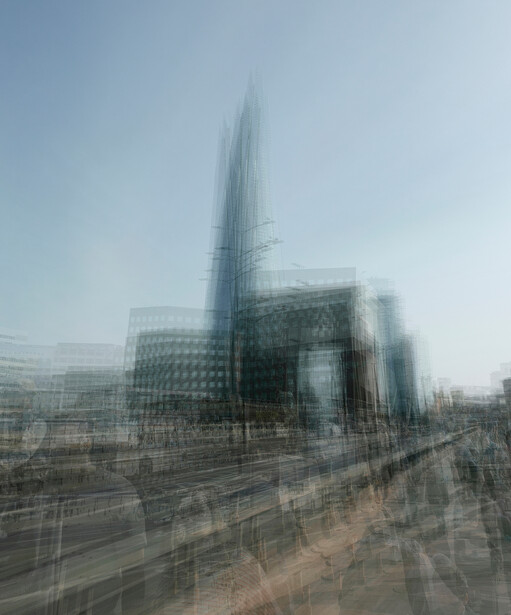 Modern skyscraper with glass facade photographed through a grid or mesh overlay, creating a layered, double-exposure effect.