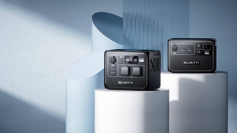 Two compact camera units displayed on white cylindrical pedestals against a minimalist backdrop with dramatic blue-tinted lighting.