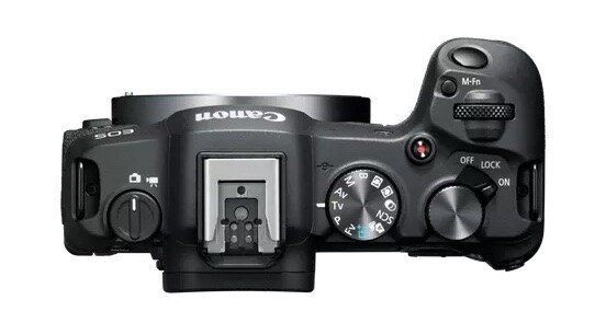 Top-down view of a Canon mirrorless camera body showing mode dial, controls, and hot shoe.