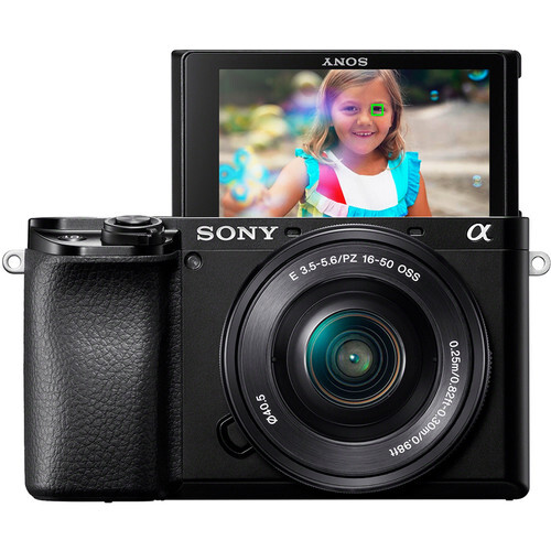 Sony Alpha a6400 mirrorless camera with flip-up LCD screen displaying a portrait of a smiling child.